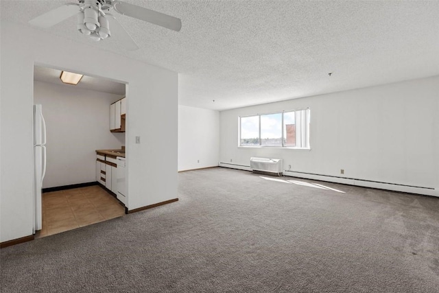 unfurnished room featuring a baseboard radiator, carpet, ceiling fan, and a textured ceiling