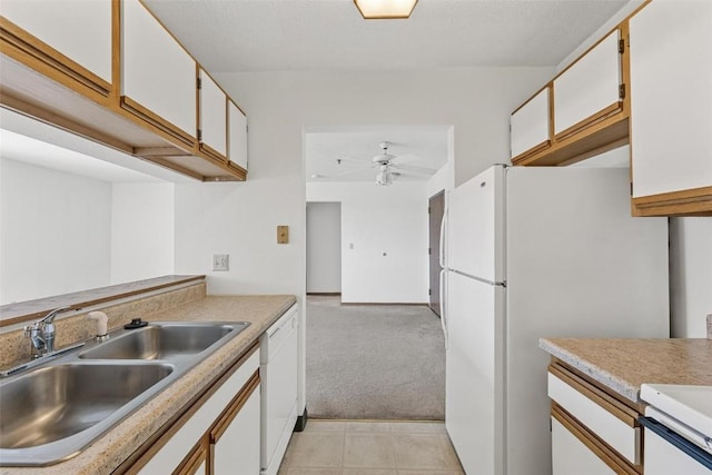 kitchen featuring sink, white appliances, ceiling fan, white cabinetry, and light colored carpet