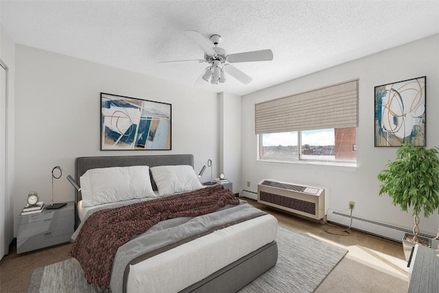 carpeted bedroom with baseboard heating, ceiling fan, a wall mounted air conditioner, and a textured ceiling