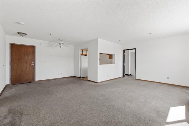 carpeted empty room with ceiling fan and a textured ceiling