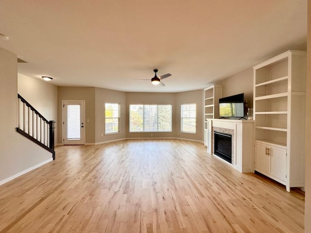 unfurnished living room with light hardwood / wood-style flooring and ceiling fan