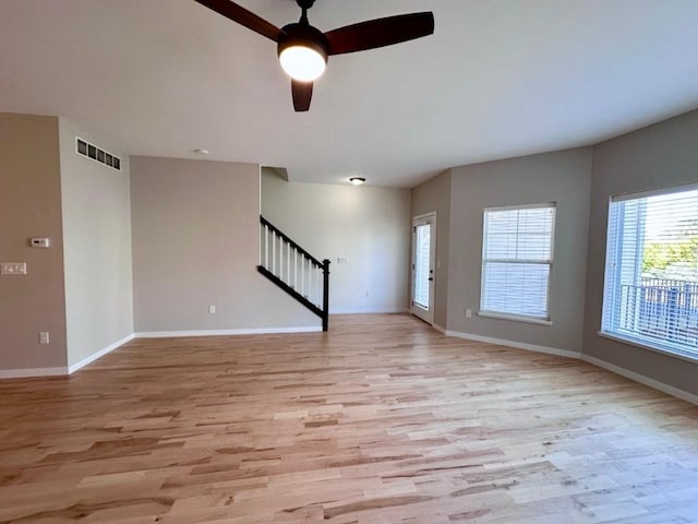 unfurnished living room featuring light hardwood / wood-style flooring and ceiling fan