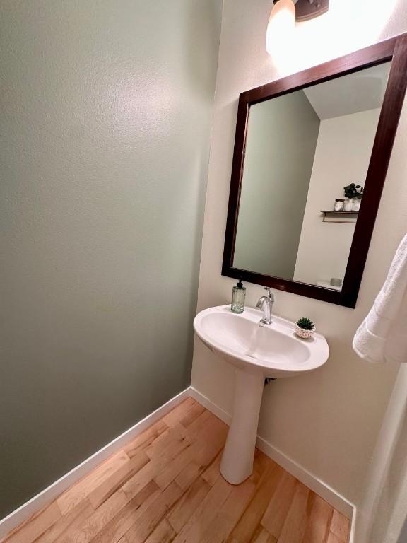 bathroom with hardwood / wood-style floors