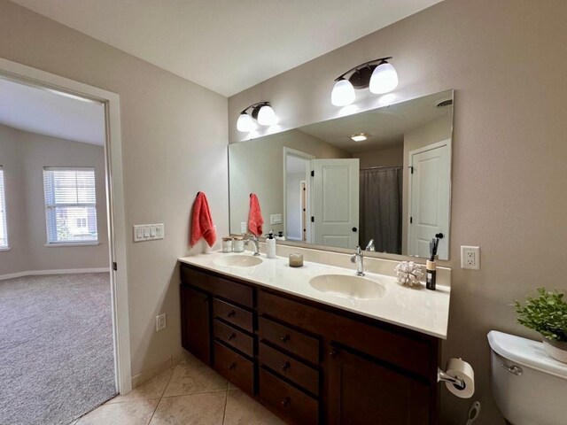 bathroom featuring vanity, tile patterned floors, and toilet