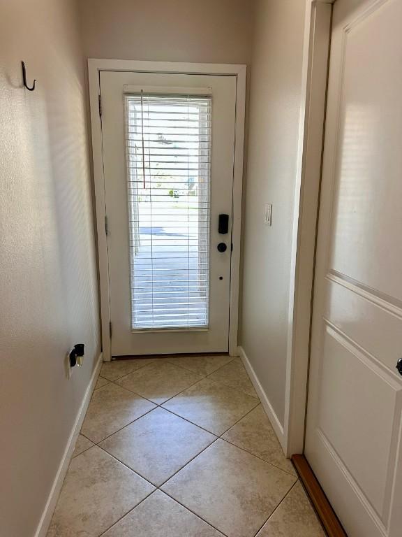 doorway to outside featuring light tile patterned floors