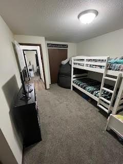 carpeted bedroom with a textured ceiling