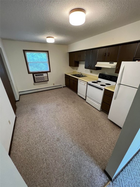 kitchen featuring dark brown cabinetry, a baseboard heating unit, white appliances, and sink