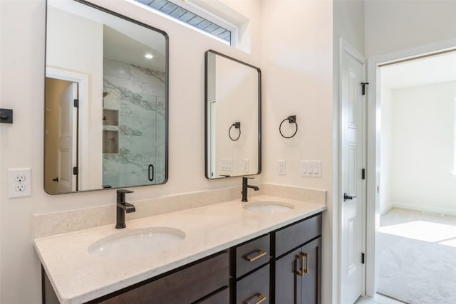 bathroom featuring walk in shower and vanity