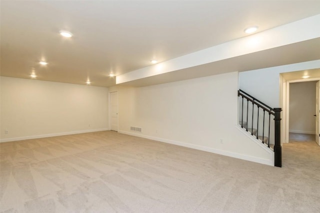 basement featuring light carpet