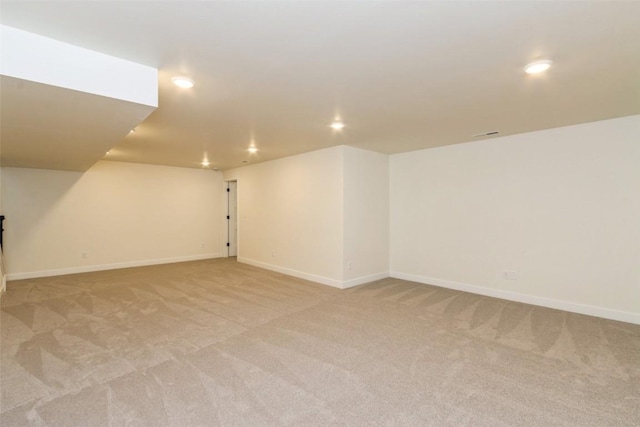 basement featuring light colored carpet