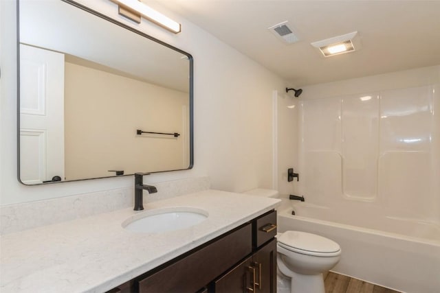 full bathroom with shower / bathtub combination, vanity, toilet, and hardwood / wood-style floors