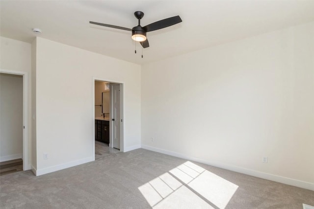 unfurnished bedroom with light carpet and ensuite bath