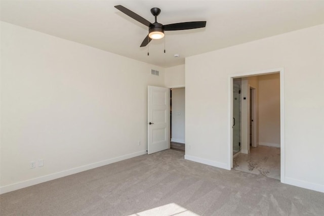 unfurnished bedroom featuring light colored carpet and ceiling fan