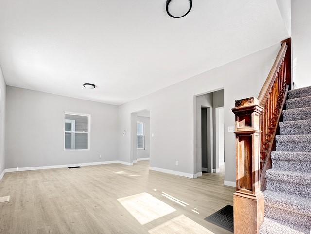 unfurnished living room with light hardwood / wood-style flooring