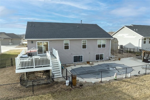 back of house with a swimming pool side deck