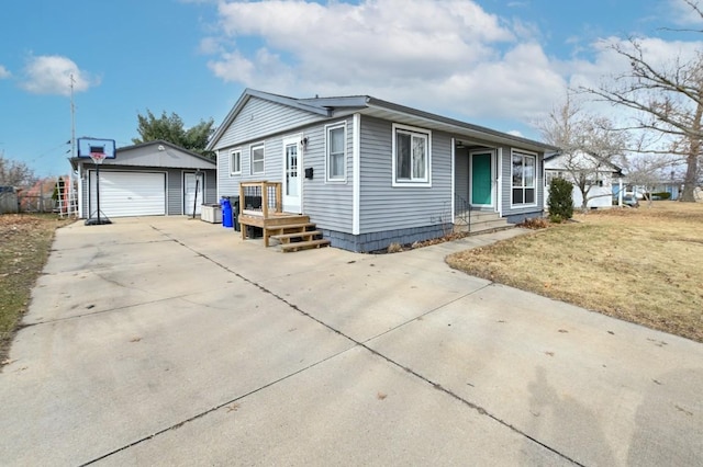 view of front facade featuring a garage, an outbuilding, and a front yard