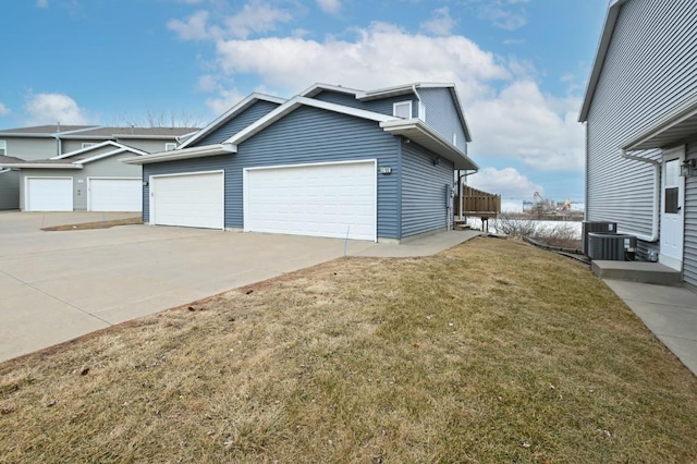 view of property exterior featuring cooling unit, a garage, and a yard