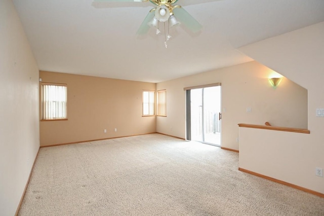 carpeted spare room with ceiling fan