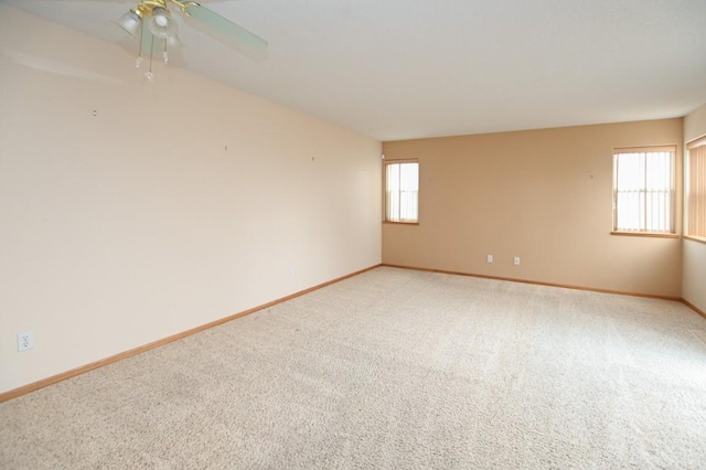 spare room with carpet floors and ceiling fan