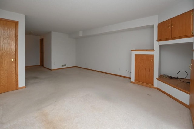 unfurnished living room with light colored carpet