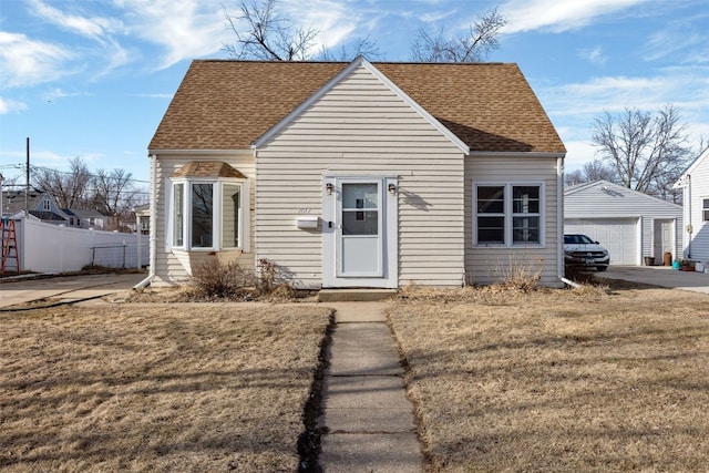 view of front facade with a garage, an outdoor structure, and a front yard