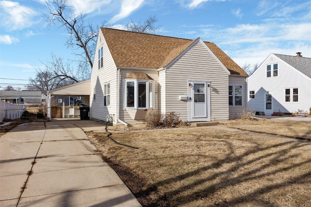 view of front of house with a carport and a front lawn