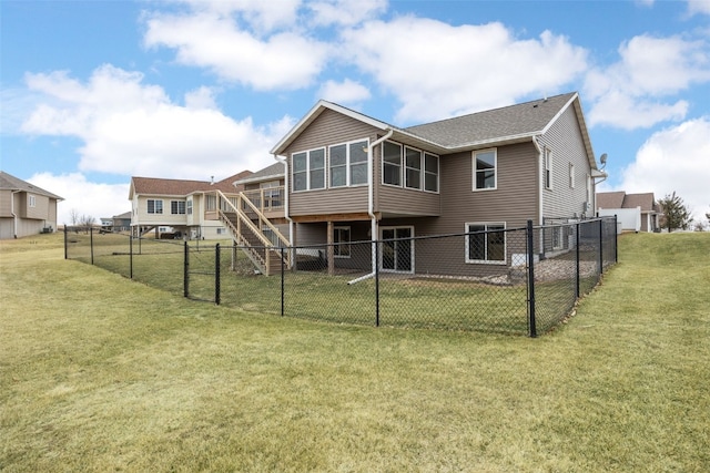 rear view of property with a sunroom and a lawn