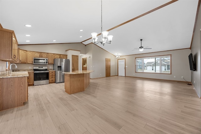 kitchen with a kitchen island, appliances with stainless steel finishes, lofted ceiling, hanging light fixtures, and light hardwood / wood-style flooring