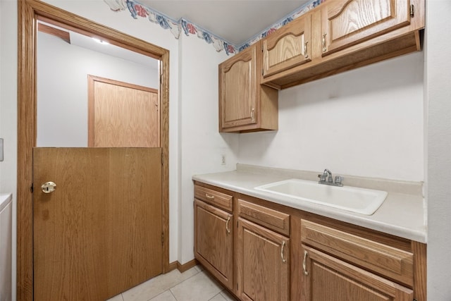 kitchen featuring sink and light tile patterned floors