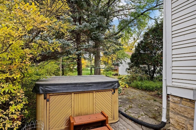 wooden terrace featuring a hot tub