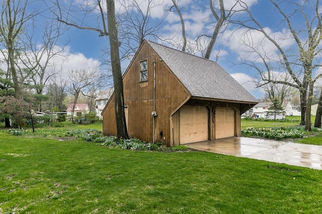 view of outbuilding with a garage and a lawn