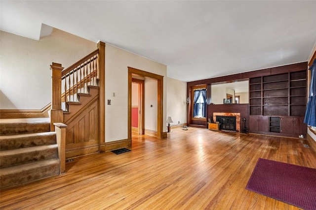 living room featuring a fireplace and wood-type flooring