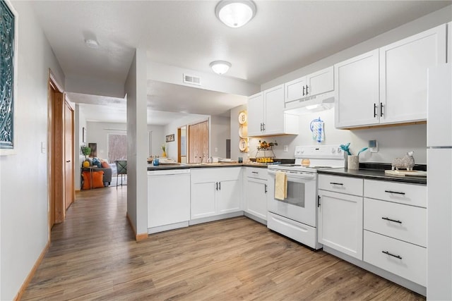 kitchen with white appliances, white cabinets, and light wood-type flooring