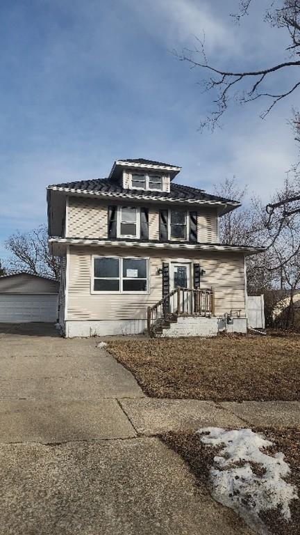 view of front of property featuring a garage and an outdoor structure