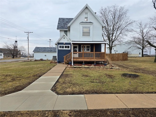 view of front of home with covered porch and a front lawn