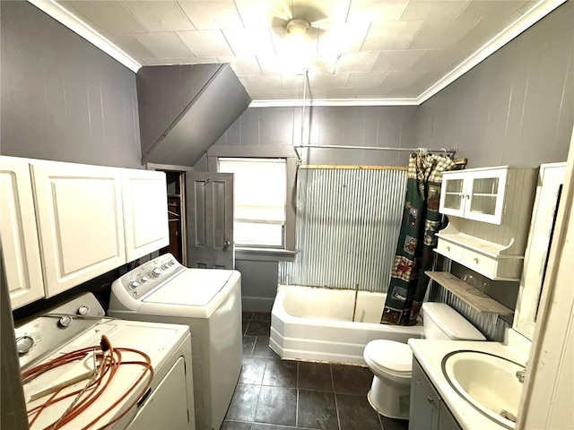 washroom with washing machine and clothes dryer, ornamental molding, sink, and dark tile patterned floors