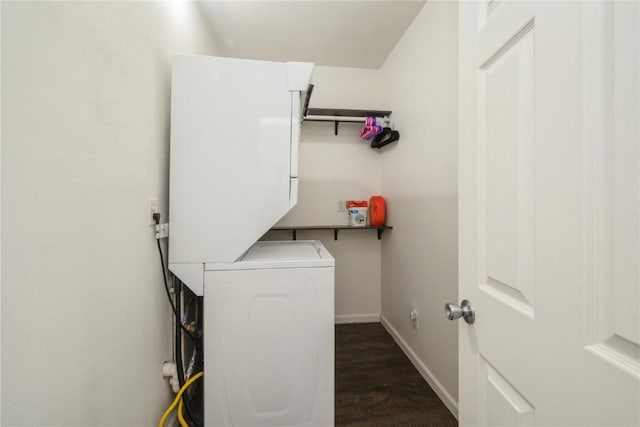 washroom with dark wood-type flooring and stacked washing maching and dryer