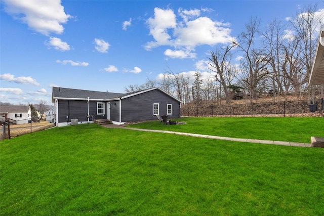 back of house featuring a lawn