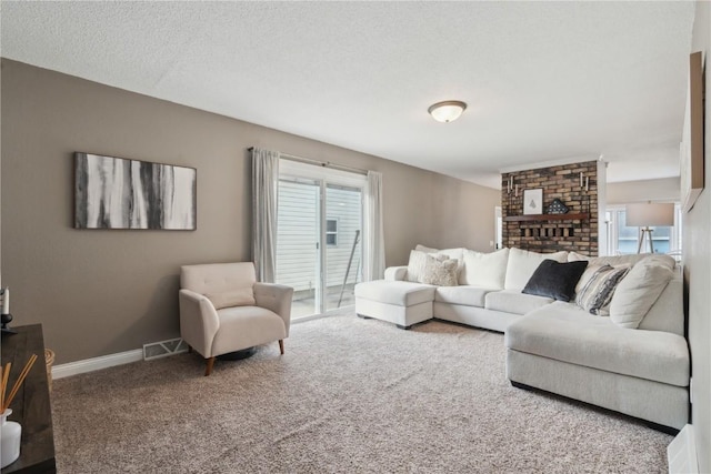 carpeted living room featuring a textured ceiling