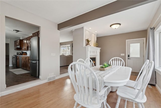 dining area with light hardwood / wood-style floors