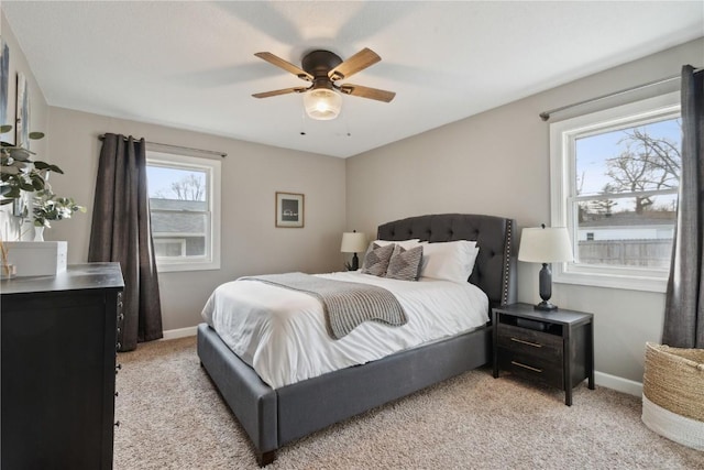 bedroom featuring light colored carpet and ceiling fan