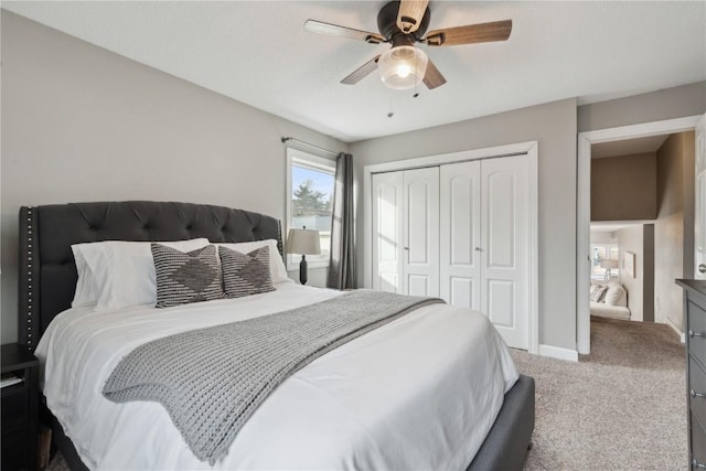 carpeted bedroom featuring ceiling fan and a closet