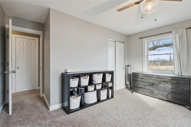 bedroom featuring ceiling fan, carpet floors, and a closet