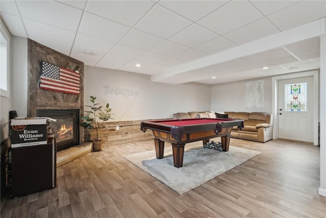 playroom featuring wood-type flooring, billiards, a large fireplace, and a paneled ceiling