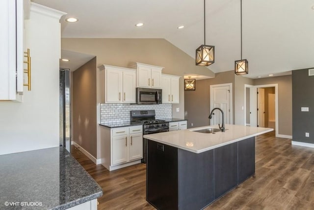 kitchen featuring stainless steel appliances, sink, hanging light fixtures, and white cabinets