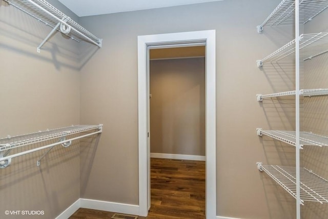 walk in closet with hardwood / wood-style floors