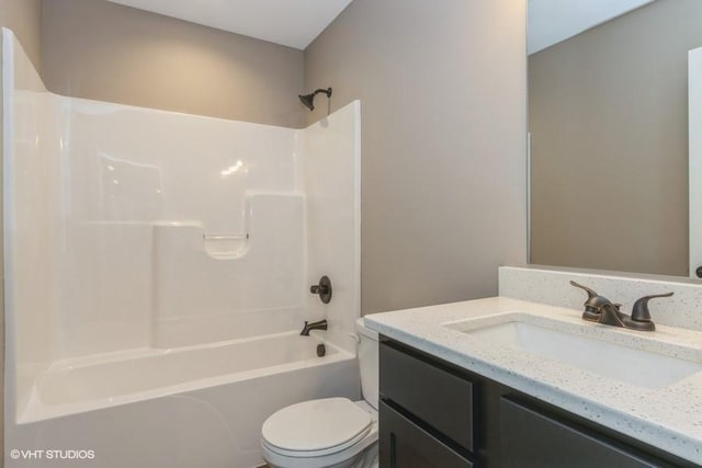 full bathroom featuring vanity, bathtub / shower combination, and toilet