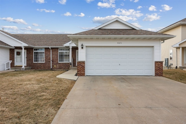 single story home with a garage and a front lawn