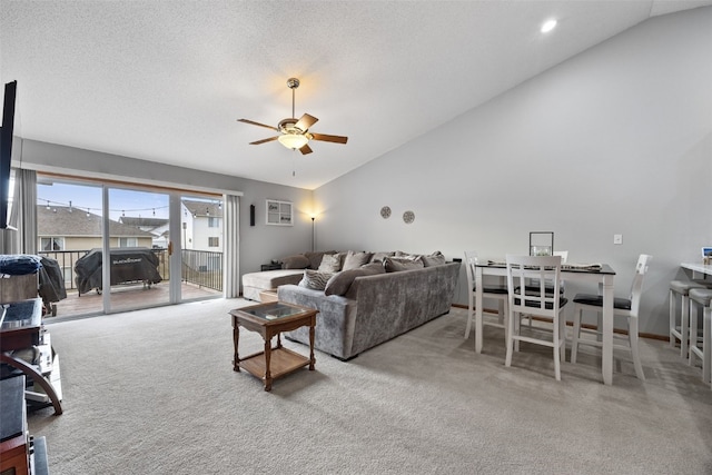 living room with high vaulted ceiling, light colored carpet, a textured ceiling, and ceiling fan