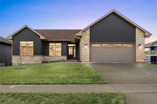 view of front facade with a garage and a lawn